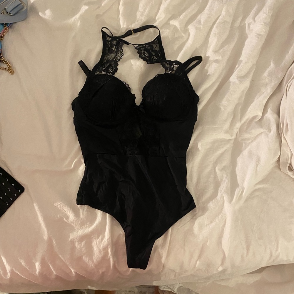 Black lace body suit with a high neck